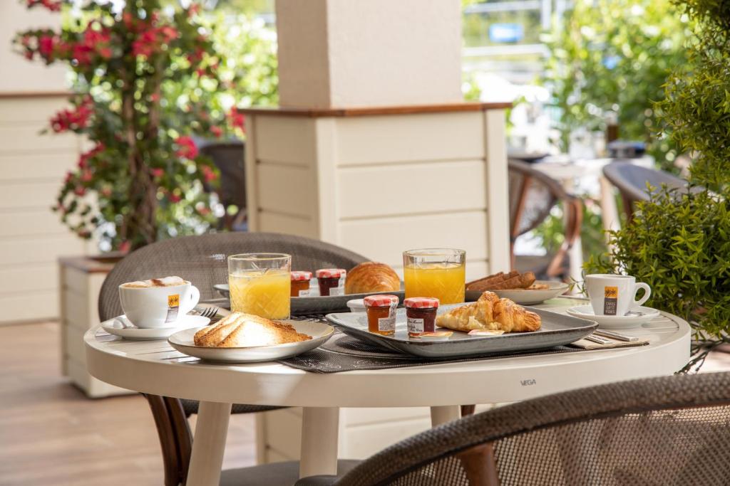 a table with breakfast foods and drinks on a patio at Blue Sail Hotel in Anse Marcel 