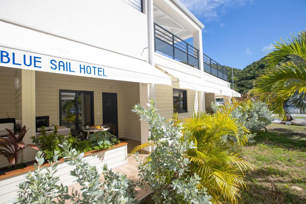 a large white house with a blue still hotel sign on it at Blue Sail Hotel in Anse Marcel 