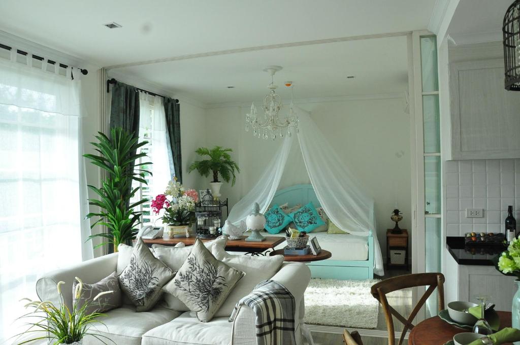 a living room with a white couch and a bed at Hua Hin-Summer Condominium in Hua Hin