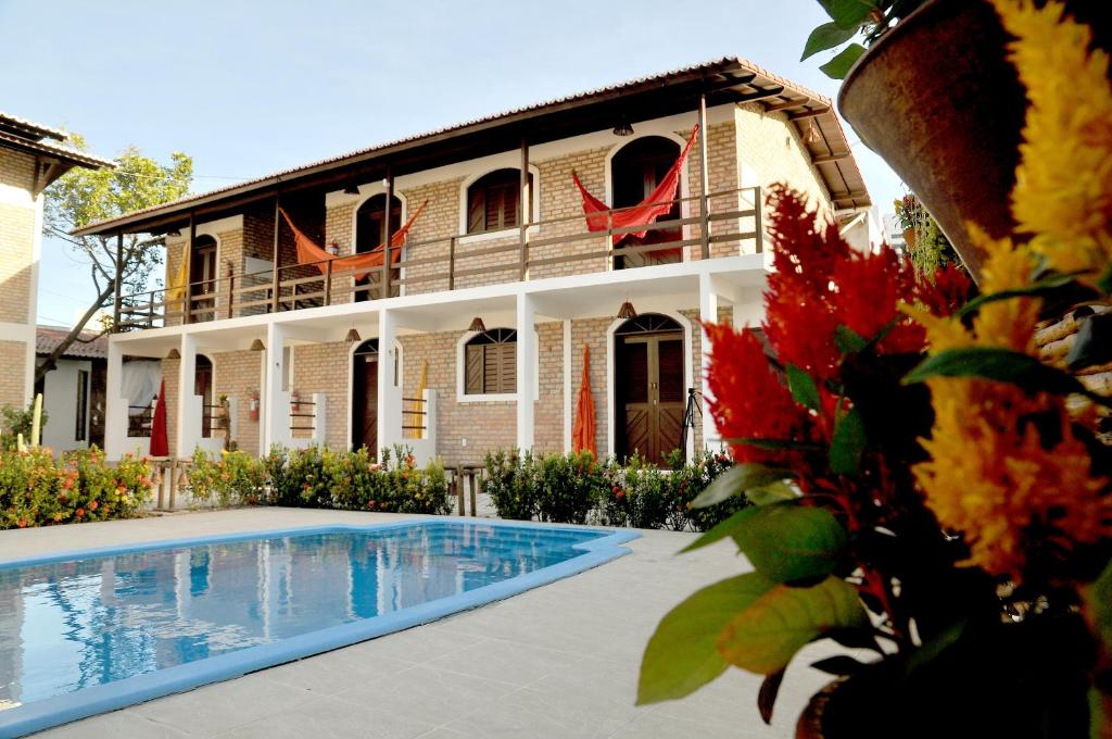 a house with a swimming pool in front of it at OXENTE Natal in Natal