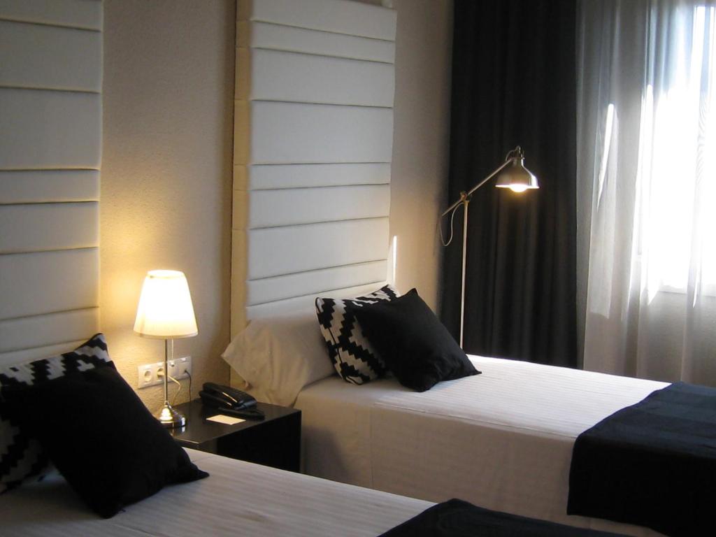 Postel nebo postele na pokoji v ubytování Habitus Hotel Leyre