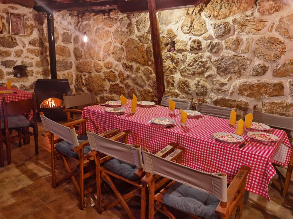 a table in a restaurant with a red table cloth at Konak -Guest house -Ramonda Serbika in Niš