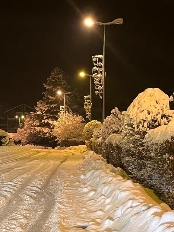 a snow covered street at night with street lights at les Cimes d'Or Mont blanc in Les Contamines-Montjoie