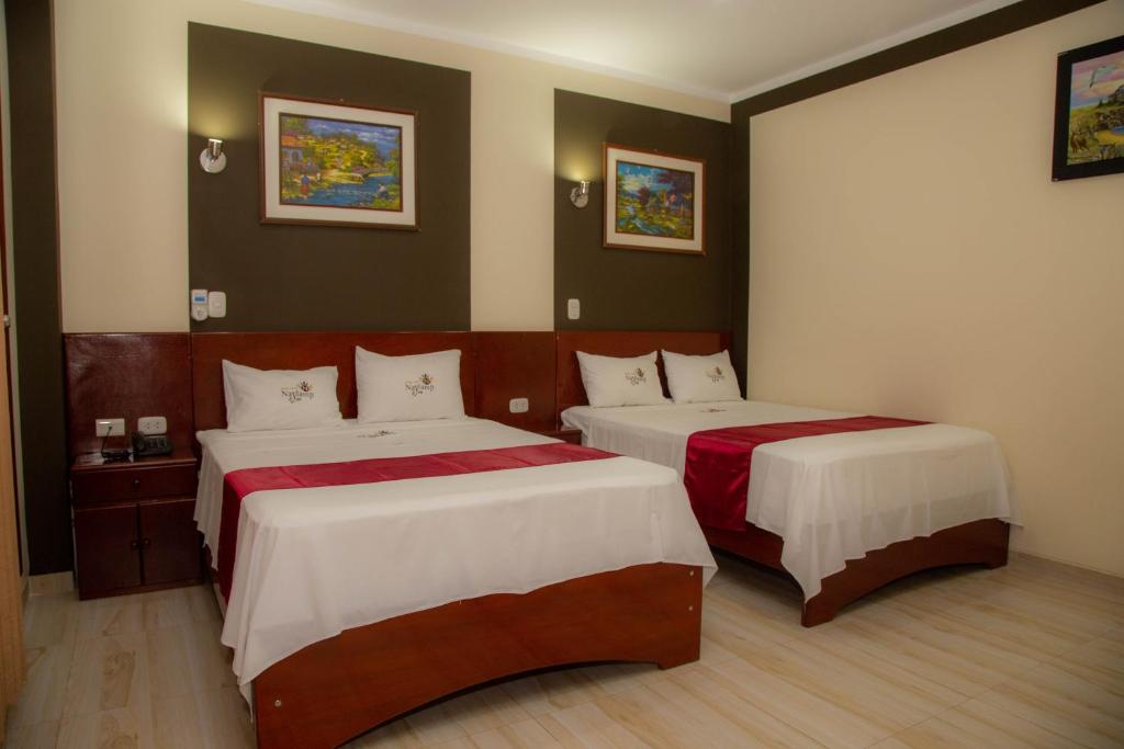 Postel nebo postele na pokoji v ubytování Hotel Suite Naylamp Zyon