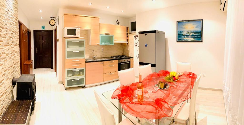 a kitchen with a table and a dining room at Apartment Marina Senj in Senj