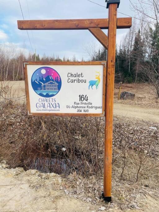 a sign on the side of a road at Chalet le Caribou- Chalets Galaxia in Saint-Alphonse-Rodriguez