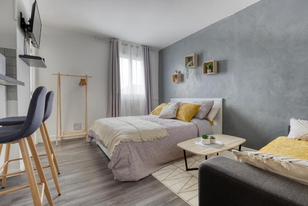 um quarto com uma cama e um sofá em Studio Proche La Défense Arena em Houilles