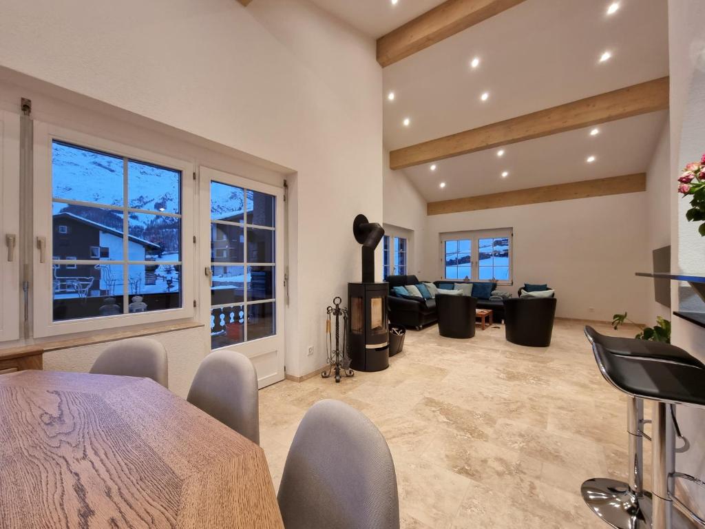 a large living room with a table and chairs at Zum Lerch Penthouse in Saas-Fee