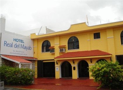 a yellow building with a red roof at Hotel Real Del Mayab in Playa del Carmen