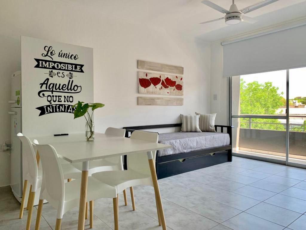 a bedroom with a bed and a table and chairs at Milan Aparts in Colón