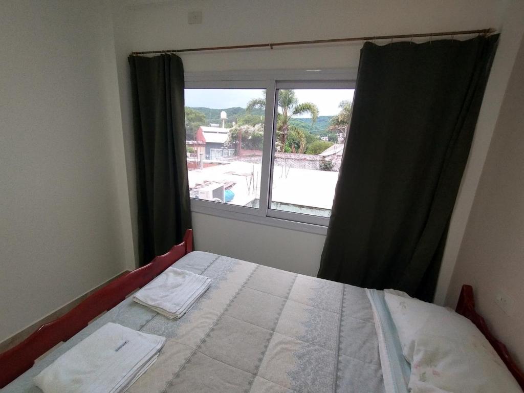 a bedroom with a bed and a large window at Habitación con baño privado en edificio 1er piso in San Salvador de Jujuy