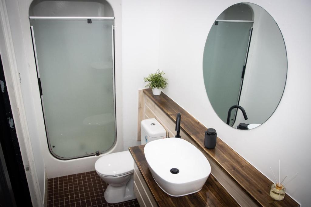 a bathroom with a toilet and a sink at Nomads Brisbane in Brisbane