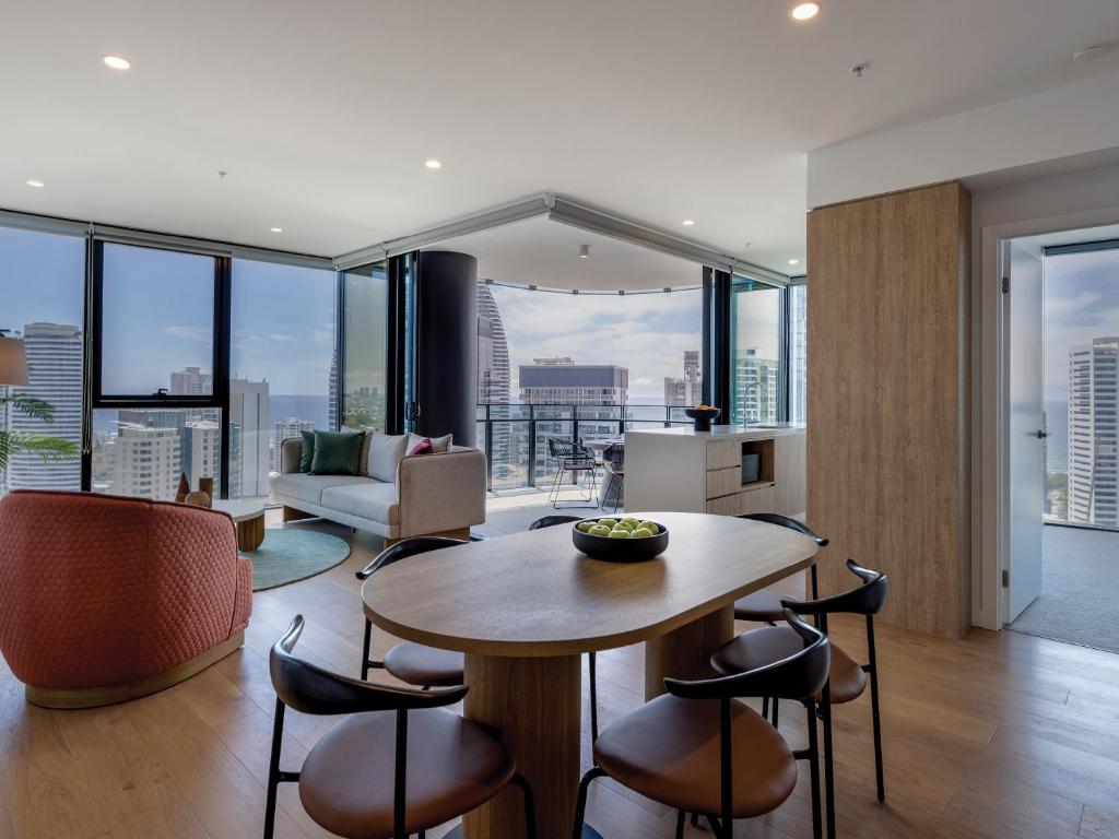 a kitchen and living room with a table and chairs at The Star Residences - Gold Coast in Gold Coast