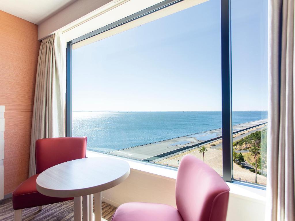 a view from a balcony of a beach with a view of the ocean at Tokyo Bay Tokyu Hotel in Tokyo