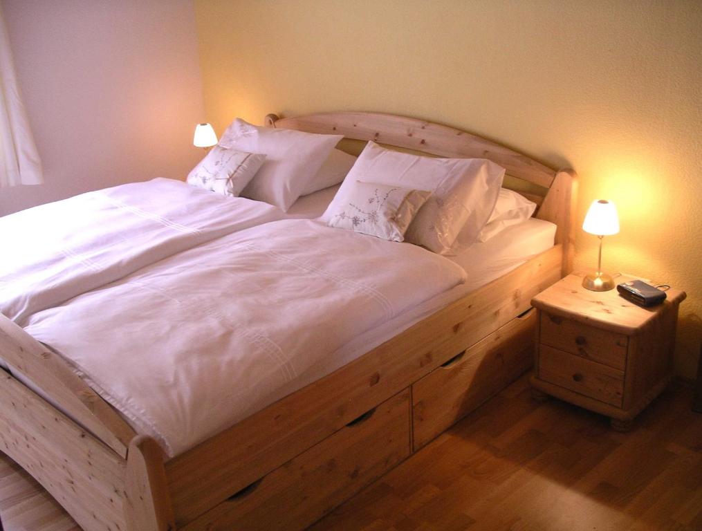 a bedroom with a large bed with white sheets and pillows at Ferienhaus Anna Maria in Bernkastel-Kues
