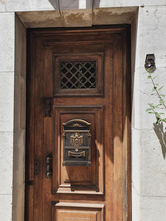 a wooden door with a sign on it at La Maison Provençale in La Roquebrussanne