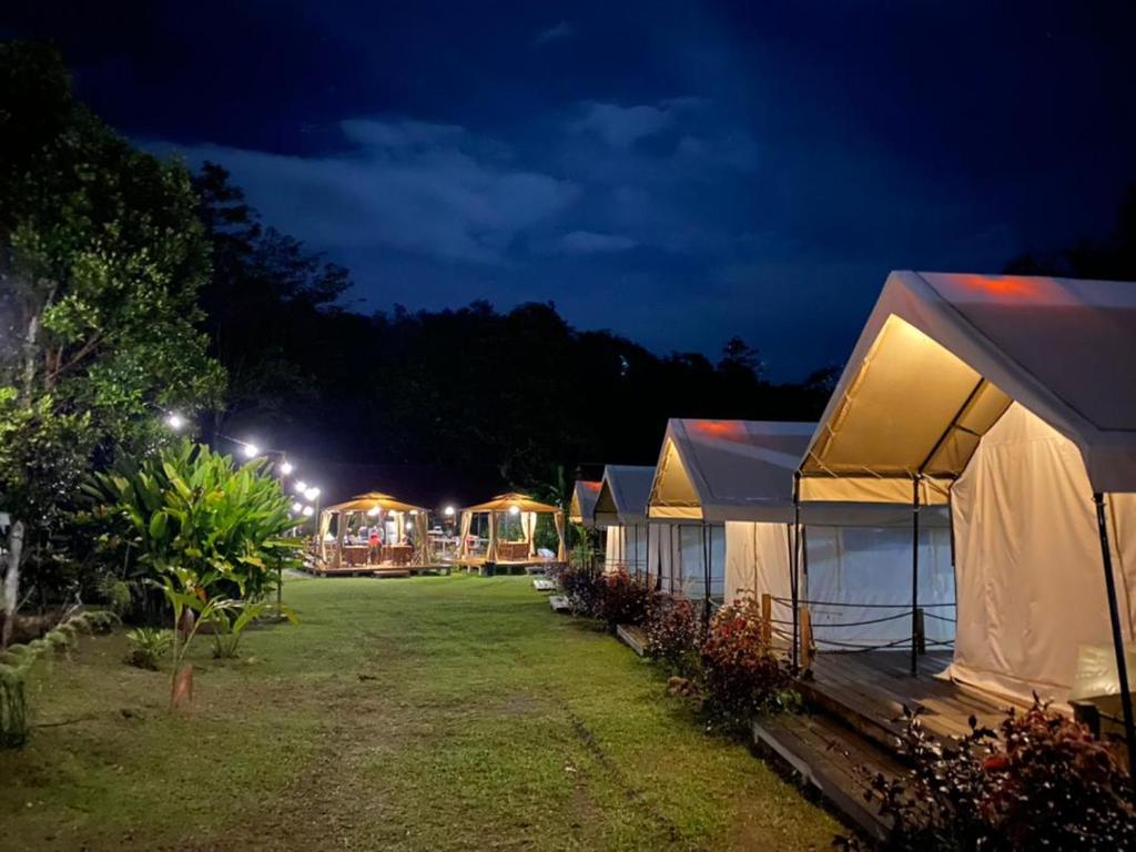 a row of tents in a yard at night at Canopy Villa Tampik Valley in Kampong Sum Sum