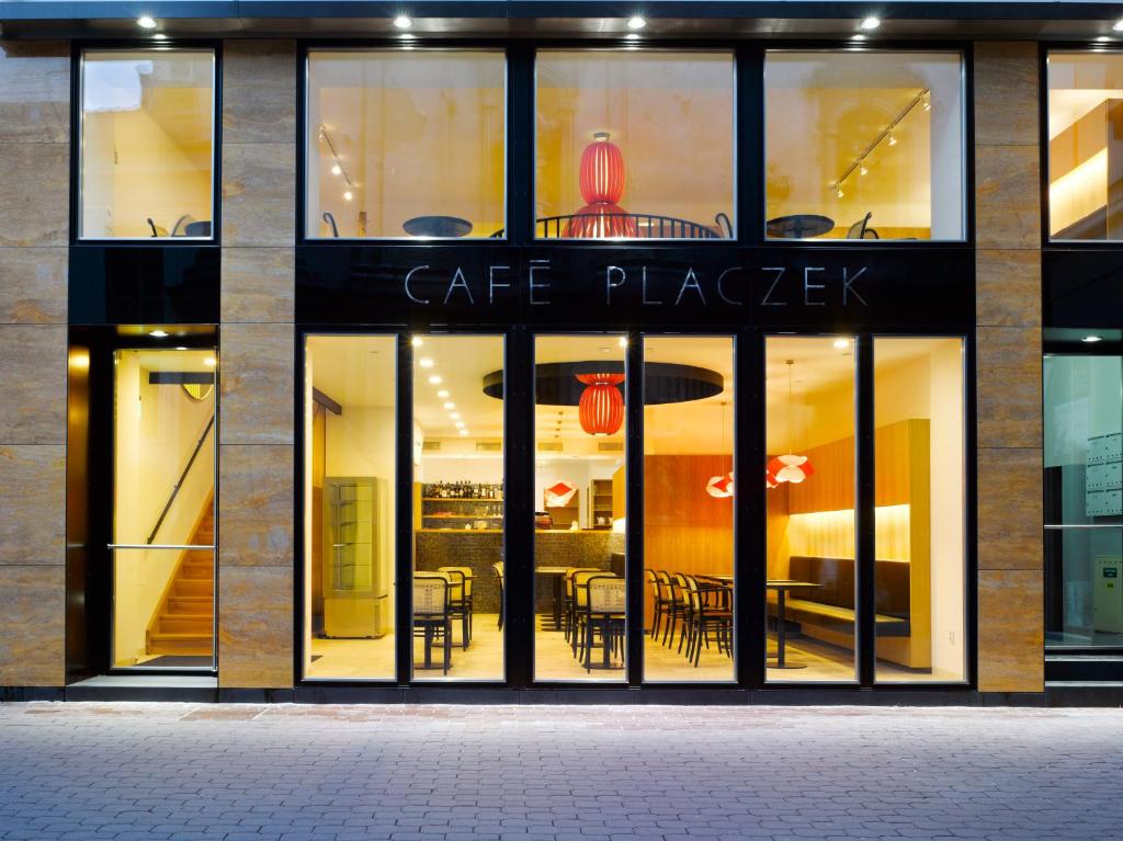 a store front of a cafe place with tables and chairs at Bed and breakfast Placzek in Brno