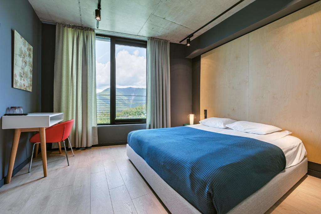Postel nebo postele na pokoji v ubytování Quadrum Hotel