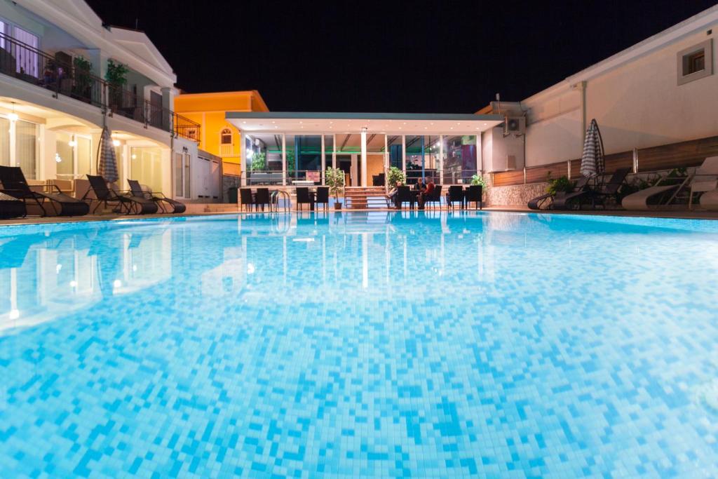 a large blue swimming pool at night at Spa Resort Luxury Apartments in Budva