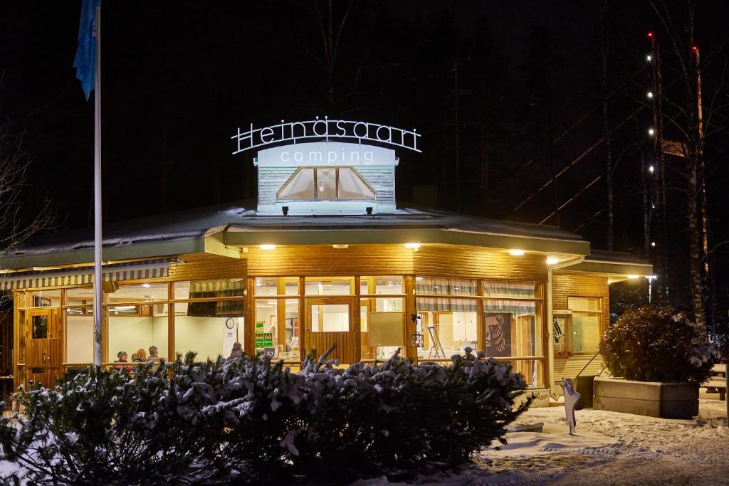 a building with a sign on top of it at night at Heinolan Heinäsaari - Holiday and Camping in Heinola