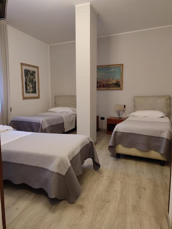 Postel nebo postele na pokoji v ubytování Hotel Cristallo