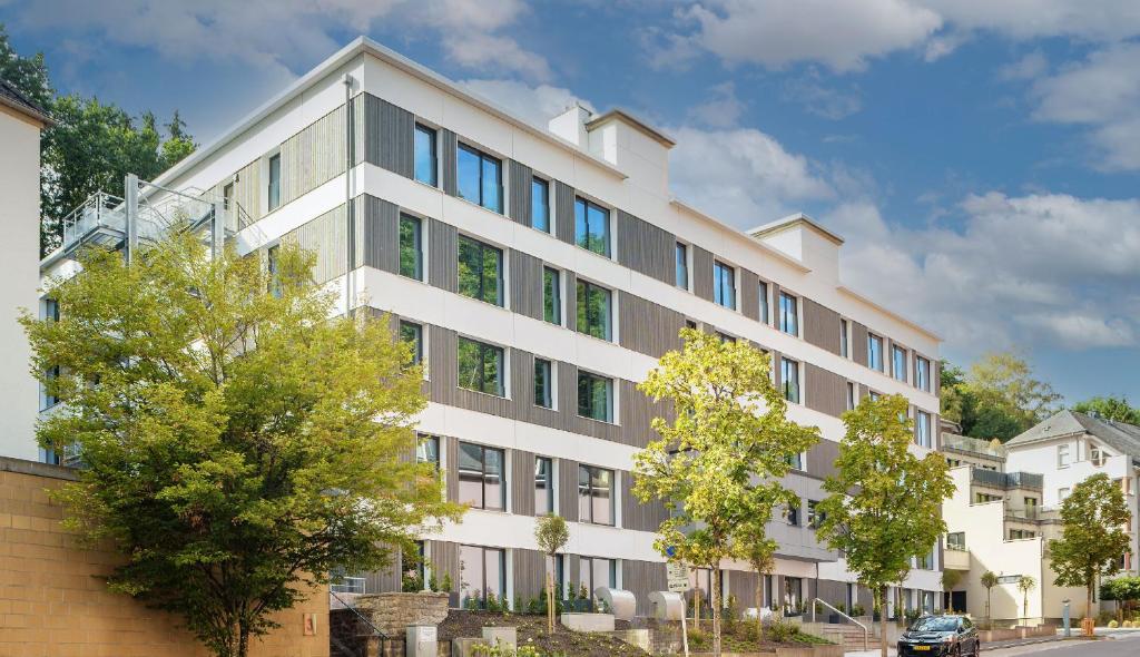 an image of a large white building at The Central Kirchberg - Smart ApartHotel in Luxembourg