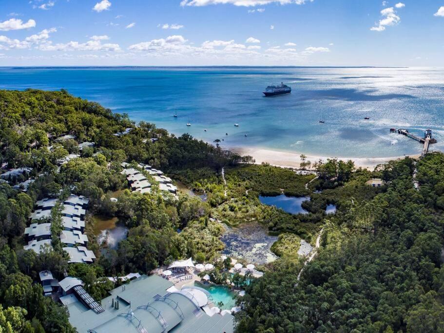 una vista aérea de un complejo con un barco en el agua en Kookaburra Villa at Kingfisher Bay Resort en Kingfisher Bay