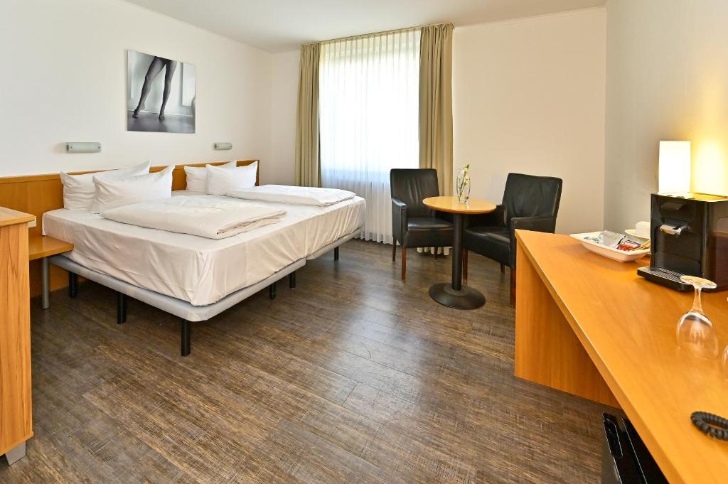 Postel nebo postele na pokoji v ubytování HESSE HOTEL Celle