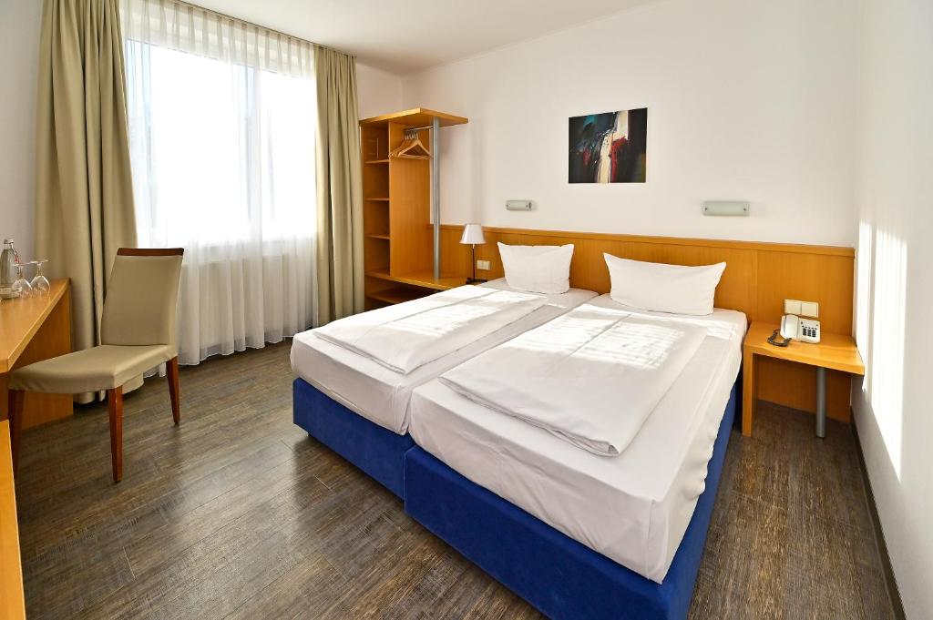 Postel nebo postele na pokoji v ubytování HESSE HOTEL Celle