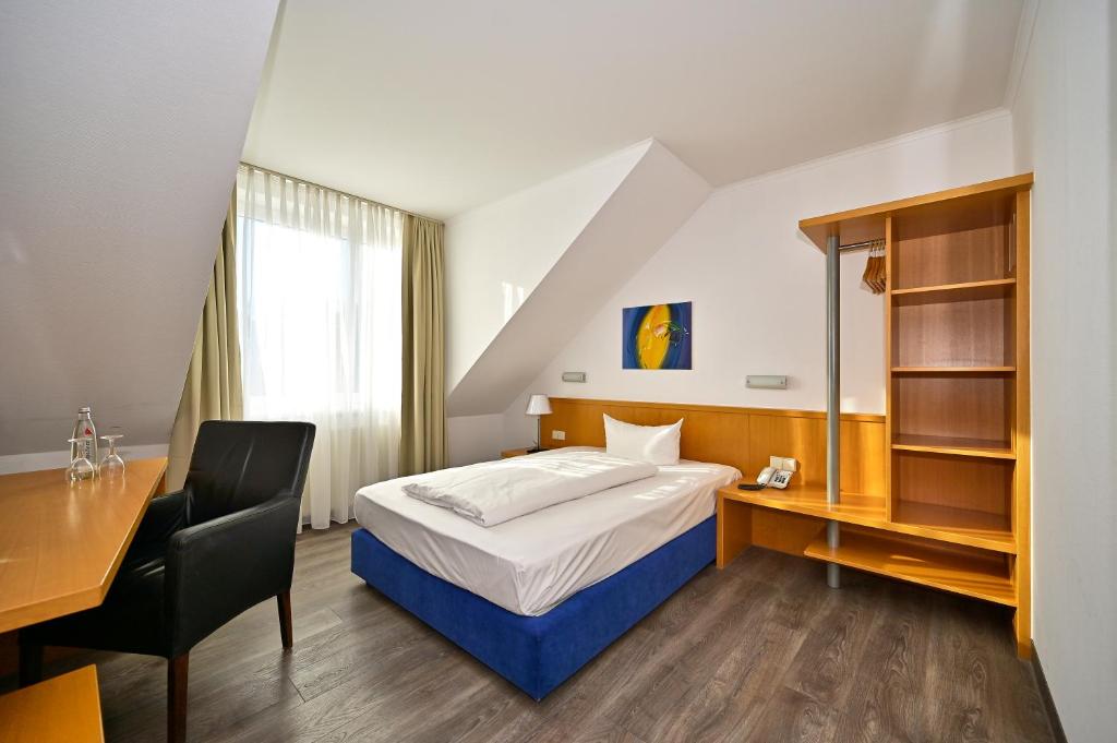 Postel nebo postele na pokoji v ubytování HESSE HOTEL Celle
