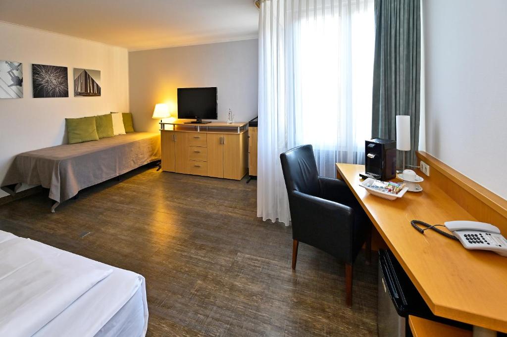 Postel nebo postele na pokoji v ubytování HESSE HOTEL Celle