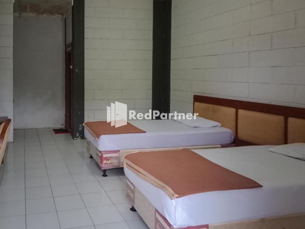 En eller flere senger på et rom på Kampung Resort Pertiwi RedPartner