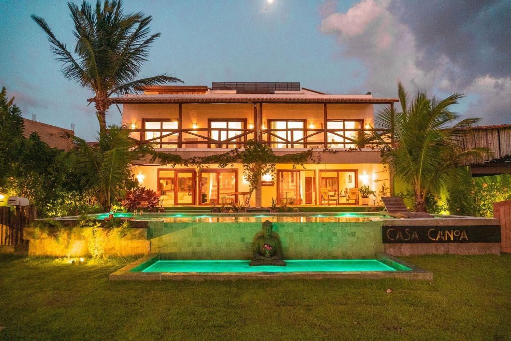 a house with a fire hydrant in front of it at Casa Canoa Camocim in Camocim