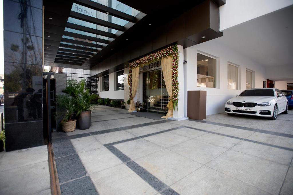 a building with a car parked in front of it at S Hotels Chennai in Chennai