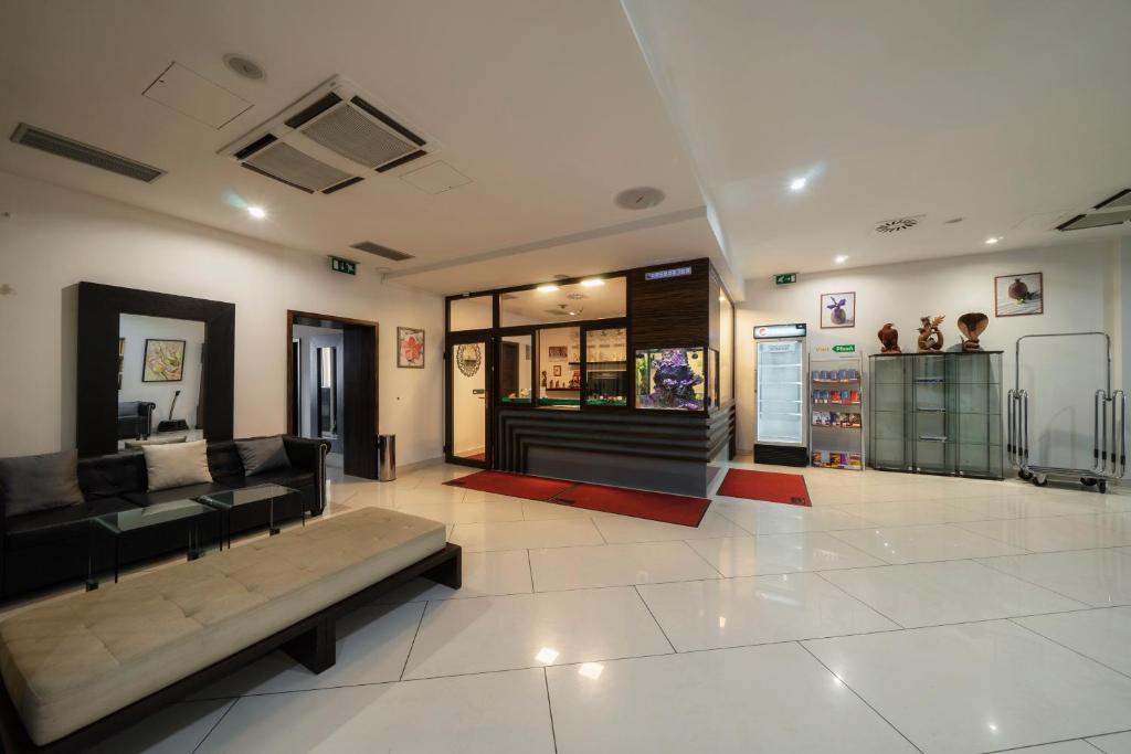 a living room with a couch and a store at Hotel Astory Plzeň in Plzeň