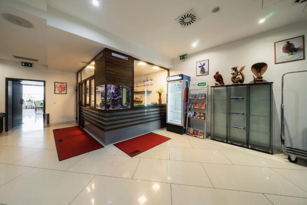 a large room with a fish tank in a store at Hotel Astory Plzeň in Plzeň