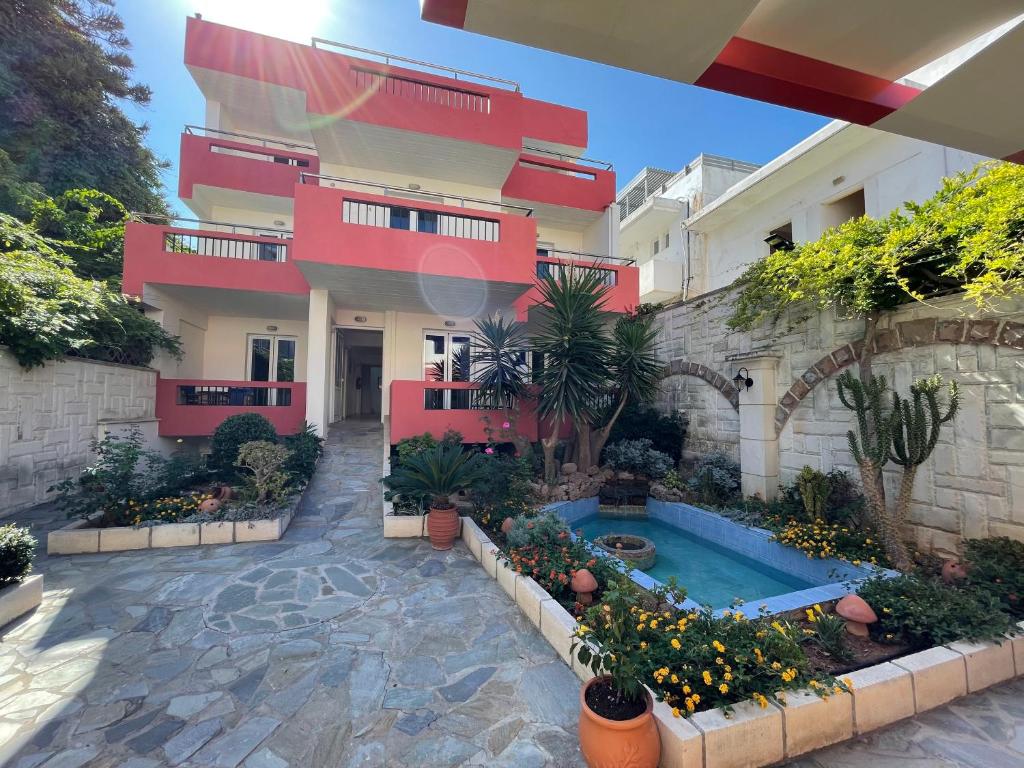 a building with a swimming pool in front of it at Flisvos in Sitia