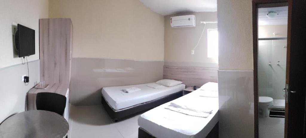 Cama ou camas em um quarto em Hotel Uzi Praia