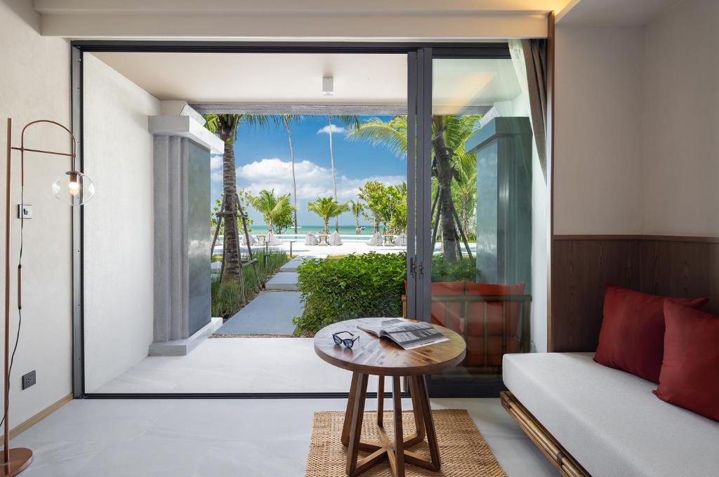 a living room with a couch and a table at The Culture Samui in Bangrak Beach