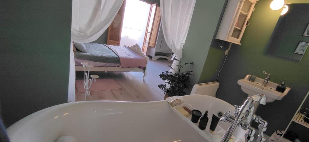 a bathroom with a bath tub and a sink at CasaBoutique cerca del mar con vistas a la montaña in Polop