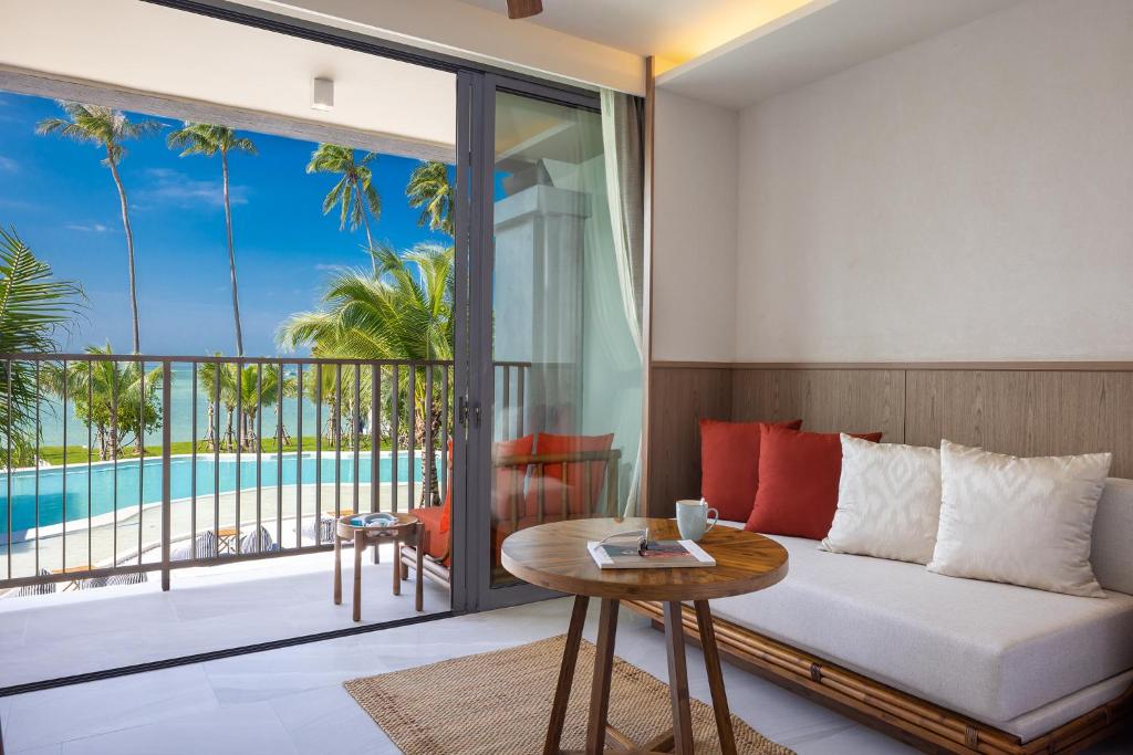 a living room with a couch and a table at The Culture Samui in Bangrak Beach