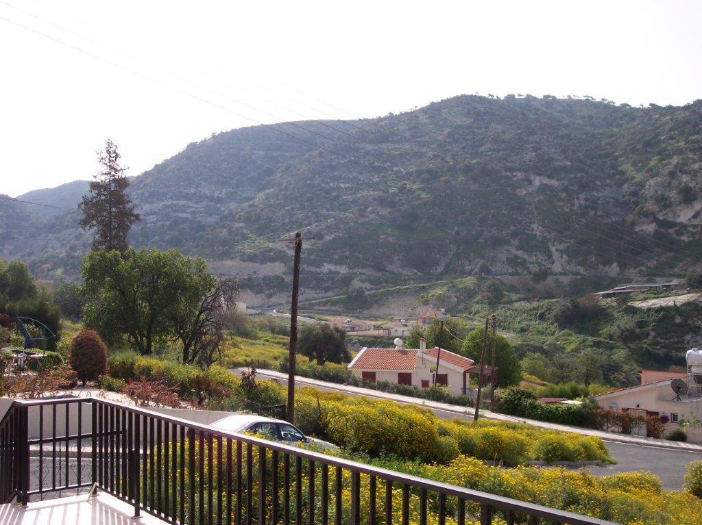a view of a mountain from a balcony of a house at Bungalow with 2 double bedrooms in the hills . in Akoursos