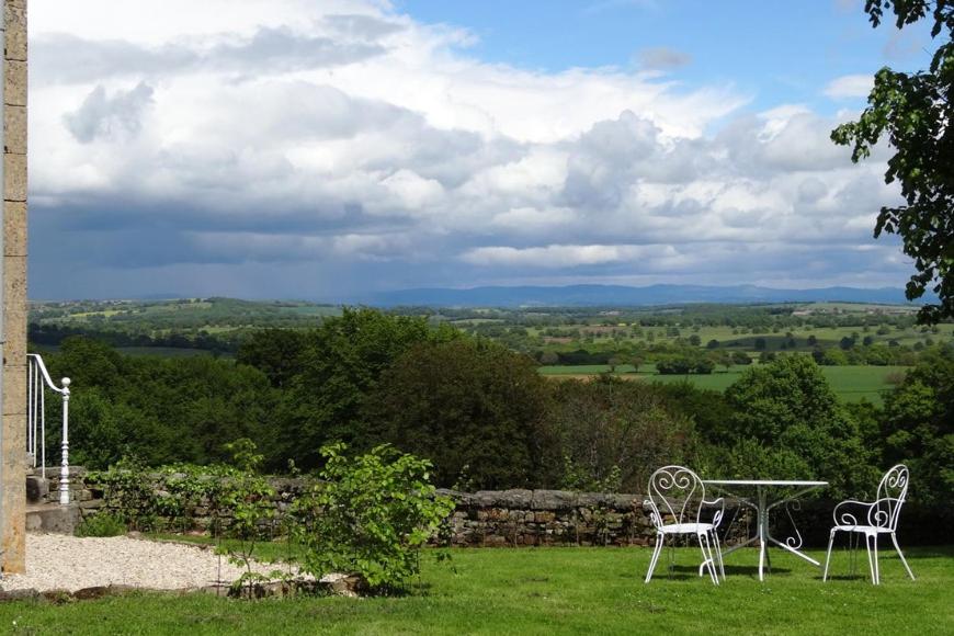 two chairs and a table on a grass field at Maison Machecourt in Champallement