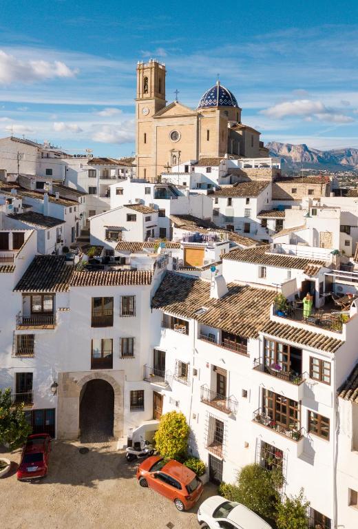 an overview of a city with white buildings and a church at Porta Nova Suites - Room Breakfast & Sea View in Altea