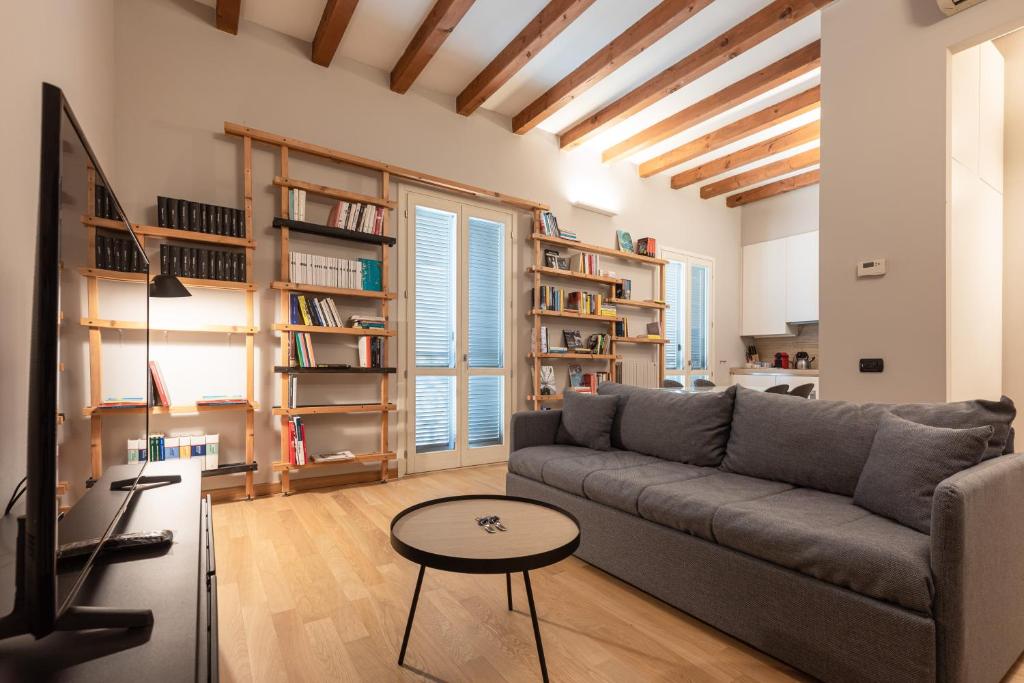 a living room with a couch and a tv at BePlace Apartments in Isola in Milan