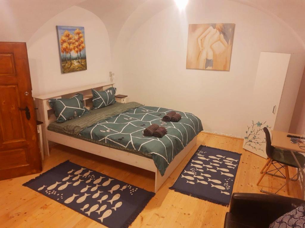 a bedroom with a bed and two rugs in it at Ica House Central in Sibiu