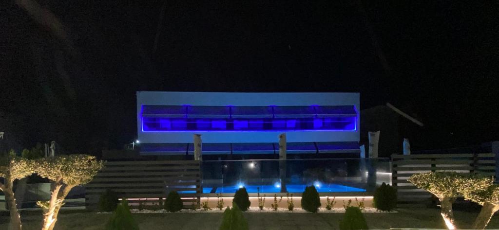 un edificio con luces azules por la noche en Anastasia Boutique Suites -Adults only & kids 12 plus, en Asprovalta