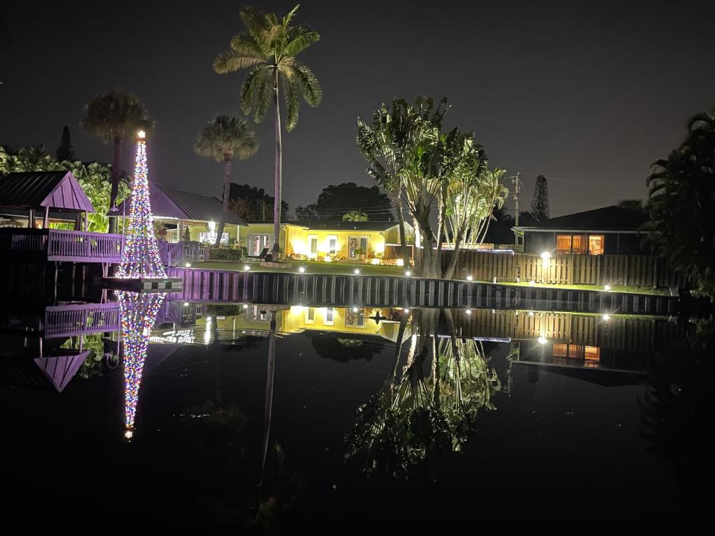 a house with lights in the water at night at Unwind Island 3 Bedrooms 3 full washrooms in West Palm Beach