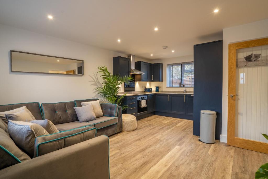 a living room with a couch and a kitchen at Mill Road Ground Floor Apartment in Crawley